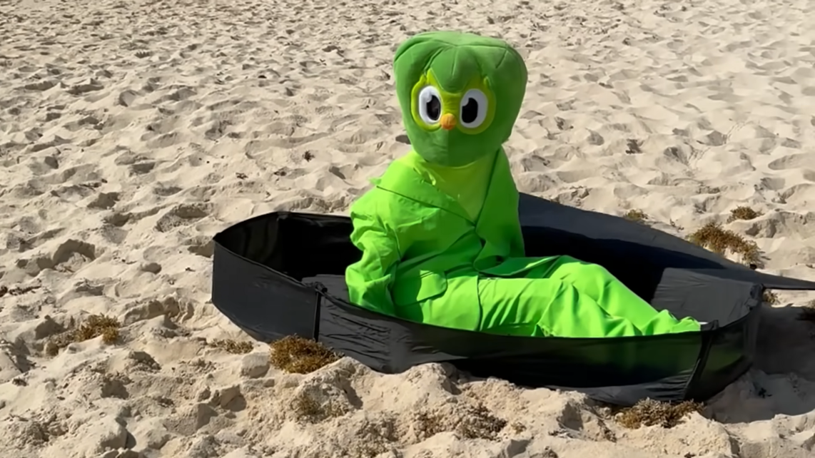 Duo waking up from a casket on a beach